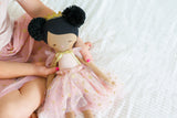 48cm ebony princess doll with black pom-pom hairstyle, blush dress, and gold ribbon bow.