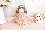 40cm soft cloth fairy doll with blush gold tulle dress and gold wings on pink surface.