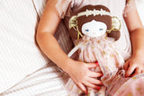 Child holding a 40cm blush gold fairy doll with a floral dress and gold wings.