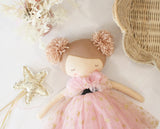 Cloth ballerina doll with strawberry blonde yarn hair in twin buns, pink tulle dress with gold stars and black ribbon.