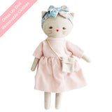 Soft beige linen cat doll wearing a pink dress, floral headband, and small white crossbody bag.