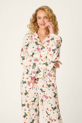 A person with curly blonde hair wears the P.J. Salvage Saddle Up Western Print Long Sleeve Top, smiling with one hand touching their face and the other arm crossed.