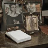 Jan Barboglio Apuntes iron notepad on a desk next to a framed photo